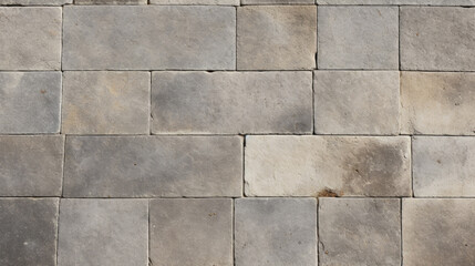 Wall Mural - Closeup of a concrete sidewalk with a rough texture, showing small tiles with a slightly worn and uneven surface. The tiles are a muted earthy tone and have a matte finish.