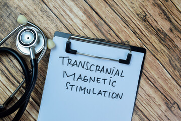 Wall Mural - Concept of Transcranial Magnetic Stimulation write on paperwork isolated on Wooden Table.