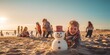 boy showing the snowman he built on the beach for Christmas Day