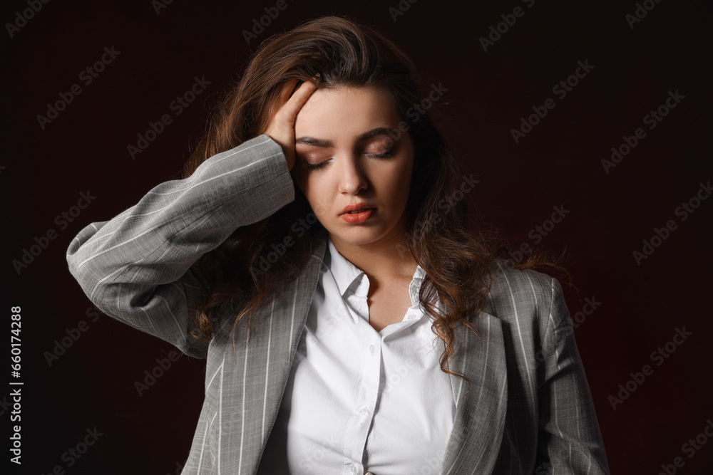Young woman having panic attack on dark background