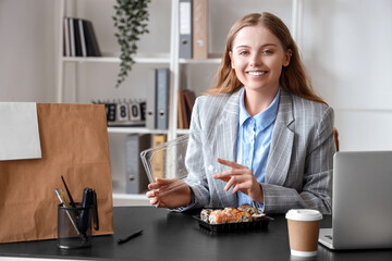 Wall Mural - Happy young woman with sushi and paper bag in office