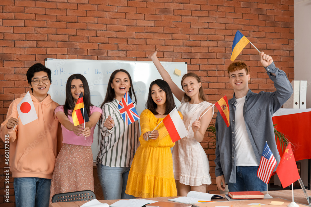 Young students with flags at language school
