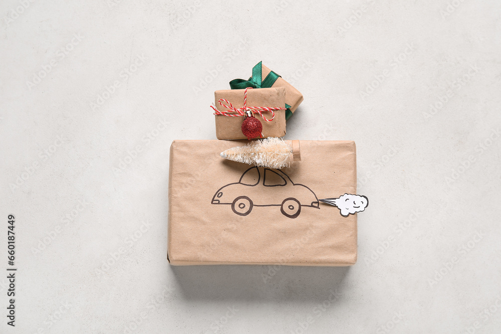 White Christmas tree and gift box with drawn car on beige background