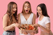 © Pixel-Shot - Female friends with tasty pizza on pink background