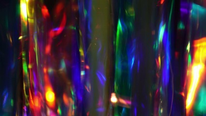 A diamond sparkling with different rainbow neon colors on a dark background. Prism Light Flares Overlay on Black Background