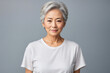 In portrait of beautiful Japanese, Korean, Asian woman with beautiful healthy facial skin Gorgeous elderly mature woman with short hair and happy smile. Beauty and cosmetics skin care advertising conc