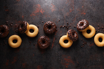 Wall Mural - Chocolate donuts and chocolate chips on dark gray background, top view