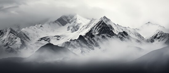 Wall Mural - snow covered peaks and cloudy alpine scenery With copyspace for text