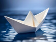 Paper boat sailing on blue water surface