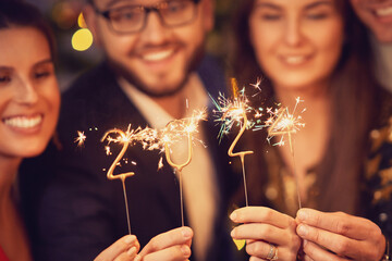 Two beautiful young couples having fun at New Year's Eve Party