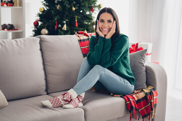 Sticker - Photo of sweet pretty girl wear xmas green pullover smiling arms cheeks sitting couch indoors home room