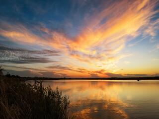 Vibrant sky reflecting on a calm and serene lake