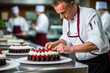 Mature male chef decorating cake in the kitchen of a restaurant or hotel