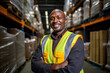 warehouse worker posing at work while smiling at the camera