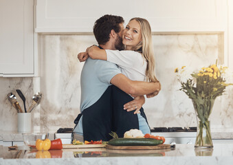 Wall Mural - Cooking, hug and happy couple in a kitchen with vegetables for organic brunch in their home together. Food, love and people embrace in a house while preparing a healthy, vegan or fresh, salad or meal