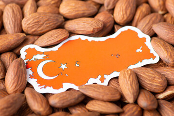 Canvas Print - Small flag and map of Turkey in almonds. Agribusiness of growing almonds in Turkey concept