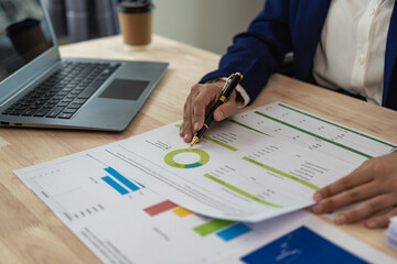 Auditor and accountant working in office Analyze financial data and accounting records with a calculator. Accounting companies provide financial and tax planning services. Close-up pictures