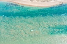 Aerial View Of Swirling Water And Sand Patterns In A Shallow Sea Water Inlet