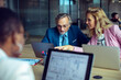 © Marko Geber - Senior businessman and young female colleague working on a project in a modern office