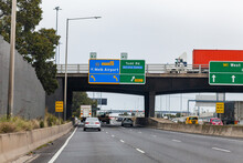 Sign To Melbourne Airport And Toll Road With Roadwork Ahead Warning