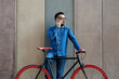 © juannovakosky - Young man on fixed gear bicycle using his smartphone