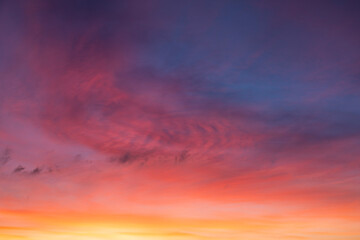 Glowing real sky at sunset texture background overlay. Dramatic red and orange clouds.