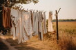Clothes hanging on a clothesline with wooden clothespins. The calm rural village life in the background. Cottagecore