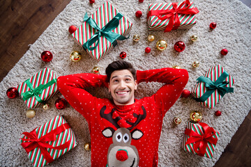 Poster - Above view photo of positive creative man lay carpet floor hands behind head imagine brainstorming giftbox tree toy balls apartment indoors