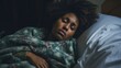 Ailing female of African American descent resting in her bed