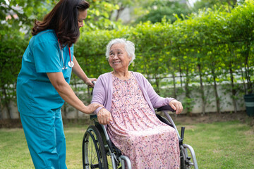 Wall Mural - Doctor help and care Asian senior woman patient sitting on wheelchair at park in nursing hospital ward, healthy strong medical concept.