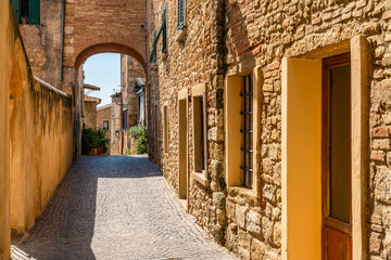 Wall Mural - The beautiful village of Bibbona on a sunny summer afternoon. Province of Livorno, Tuscany, Italy.