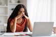 © Prostock-studio - Exhausted young eastern brunette woman employee working on laptop