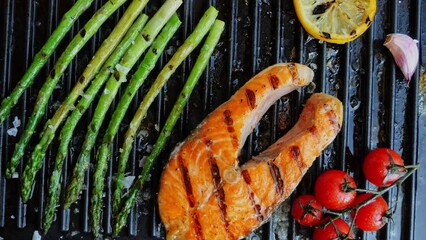 Sticker - Grilled salmon steak with asparagus tomato and lemon on grill. Top view