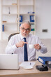 © Elnur - Old male employee drinking coffee during break