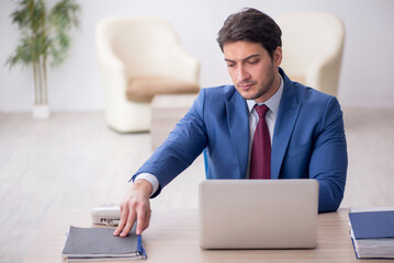 Young male employee working in the office