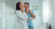 © Clement C/peopleimages.com - Couple, bathroom and cleaning face for skincare, routine and comic joke with cream, serum and product. Man, woman and funny with facial oil moisturiser for health, wellness and self care in apartment
