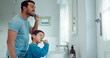 © Clement C/peopleimages.com - Father, child and brushing teeth in family home bathroom while learning or teaching dental hygiene. A man and kid with toothbrush and toothpaste for health, cleaning mouth and wellness at mirror