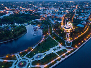 Wall Mural - Scenic view from drone of medieval Yaroslavl Orthodox Assumption cathedral on background with Volga River and cityscape at night, Russia..