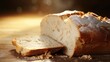 Closeup of a piece of bread torn in half, symbolizing the act of sharing and breaking bread together as a community of believers.