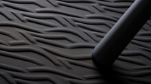 Texture of a grooved rubber golf grip, featuring a diagonal pattern of raised ridges for enhanced traction and control during swings. The rubber is also cushioned to reduce hand fatigue.