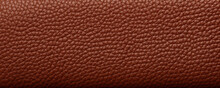 Texture Of Pigskin Leather, Showcasing A Raw, Unprocessed Look With A Rugged, Earthy Feel. The Deep Terracotta Color Has Natural Variations And Imperfections, Adding To The Organic And Natural