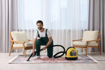 Canvas Print - Dry cleaner's employee hoovering carpet with vacuum cleaner in room