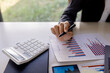 © David - Businessman working at office with documents on his desk, doing planning analyzing the financial report, business plan investment, finance analysis concept