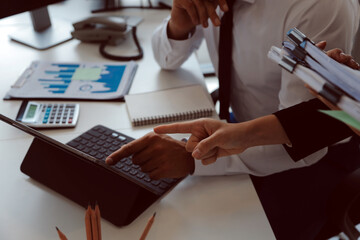 Close up of Business team analyzing income charts and graphs with modern laptop computer. Business analysis and strategy concept.