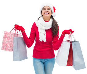 Sticker - Digital png photo of happy woman in santa hat holding gifts on transparent background