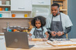 african afro black daughter kids with dad father and mom enjoy cooking class family funny internet learning by laptop . Black african family afro hair look computer for learn cooking in the kitchen