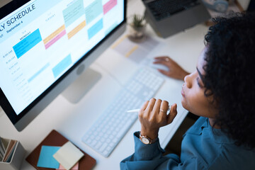 Woman with computer, thinking and checking schedule, agenda and reminder for office administration. Online calendar, planner and girl at desk planning spreadsheet for time management with high angle.