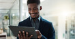 © N F/peopleimages.com - Tablet, networking and businessman in the office typing a message on the internet or mobile app. Digital technology, chatting and African male lawyer scroll on social media or website in workplace.