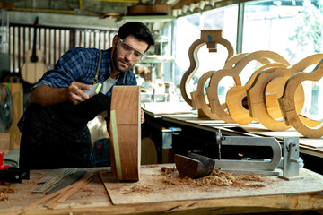 Wall Mural - Luthier Sanding Acoustic Guitar Body in Workshop