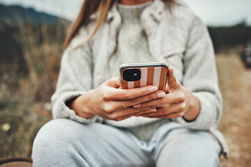 Canvas Print - Nature, hands and closeup of woman on a phone networking on social media, mobile app or the internet. Technology, mountain and female person typing a text message on cellphone in the countryside.